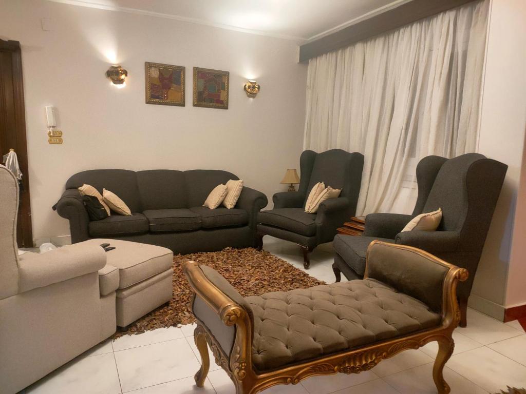 a living room with two couches and a couch at القاهره in Cairo