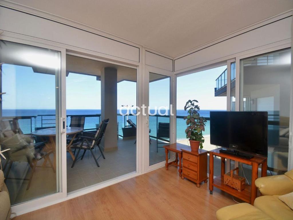 a living room with a television and a dining table at Fanals 5B in Platja d'Aro