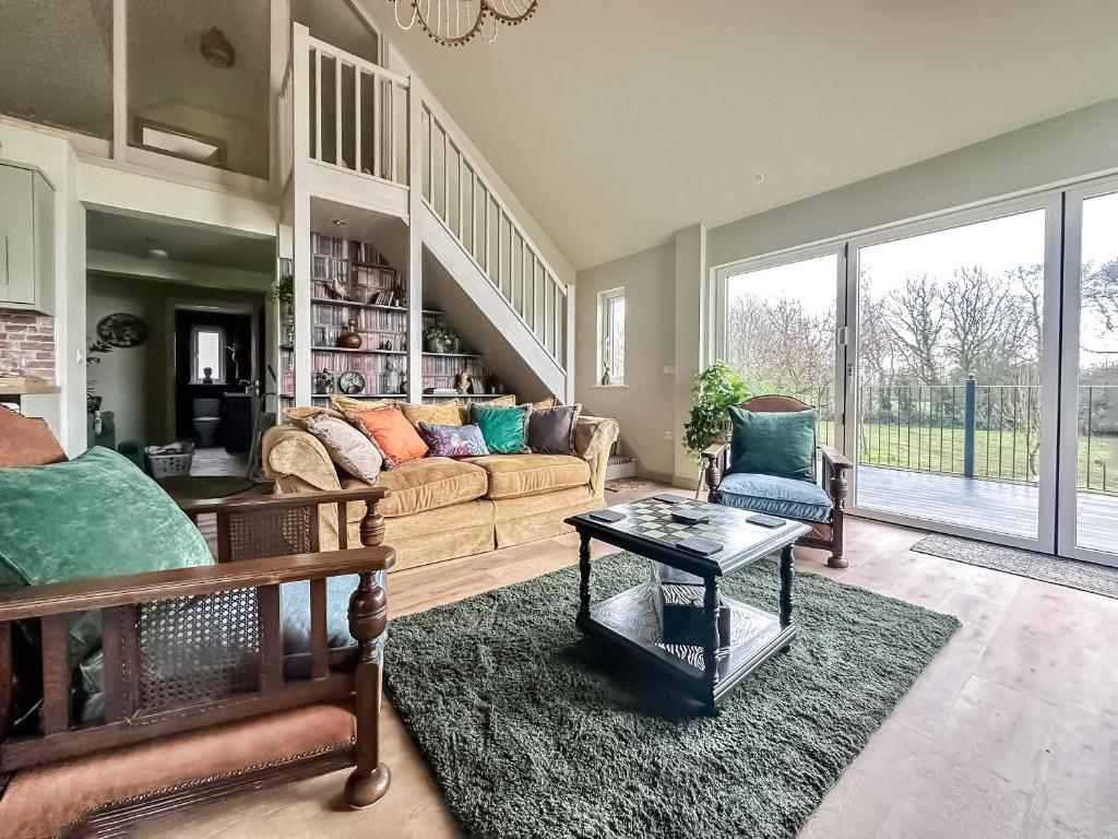 a living room with a couch and a table at Talltrees - Uk42842 in Uplowman