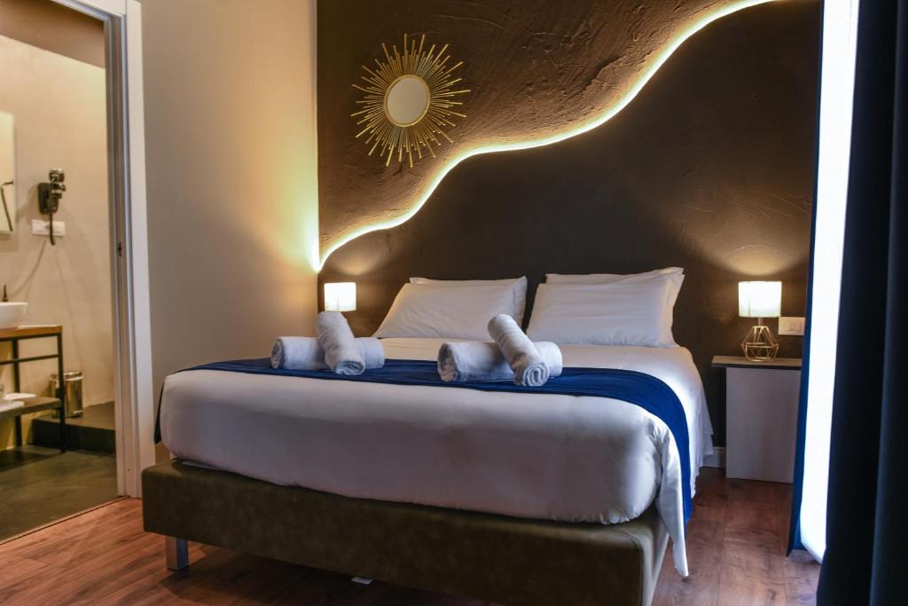 a bedroom with a large bed with a large headboard at Il Corso Comfort Rooms in Rome