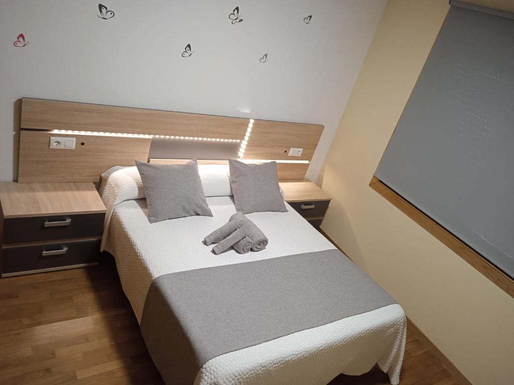 a bedroom with a bed with a hand on it at Apartamento Mirabel in Rosal