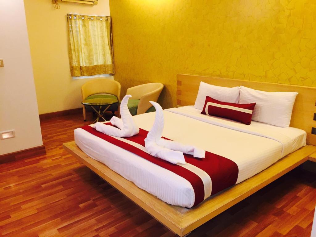 a bedroom with a bed with two swans on it at Octave Hotel & Spa - Marathahalli in Bangalore