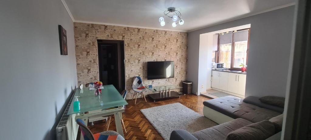 a living room with a couch and a table at Comfort Home Apartment 1 in Petroşani