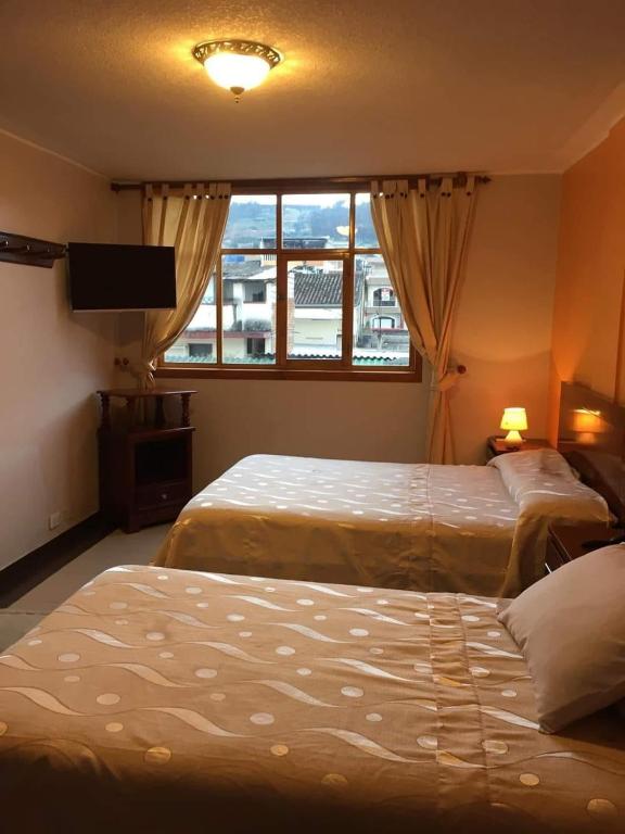 Postel nebo postele na pokoji v ubytování HOTEL El INDIO