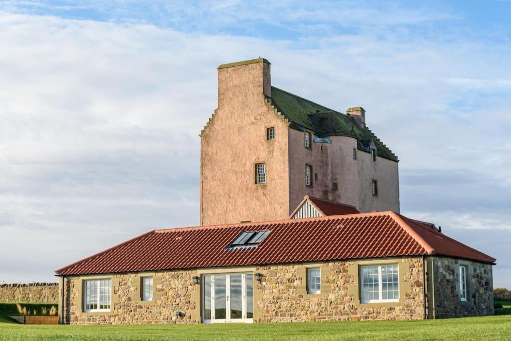 a large brick building with a tower on top of it at Fenton Lodge in North Berwick