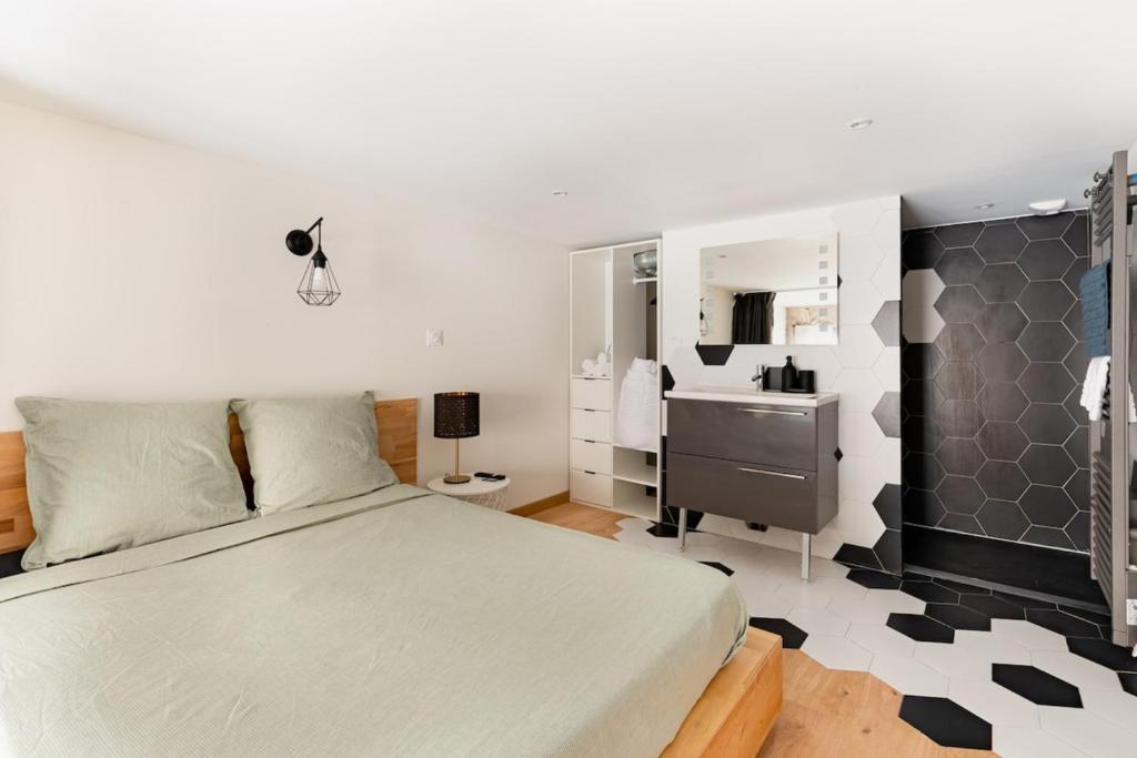 a bedroom with a bed and a sink at Le Charmant Hypercentre tram design in Saint-Étienne