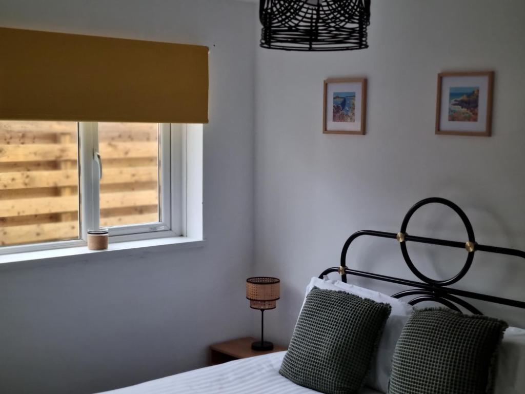 a bedroom with a bed and a window at Seaview in Trevilley