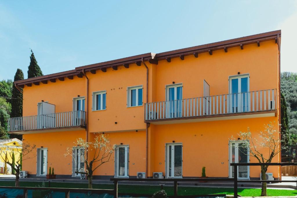 an orange building with balconies on it at 23Apartments in La Spezia