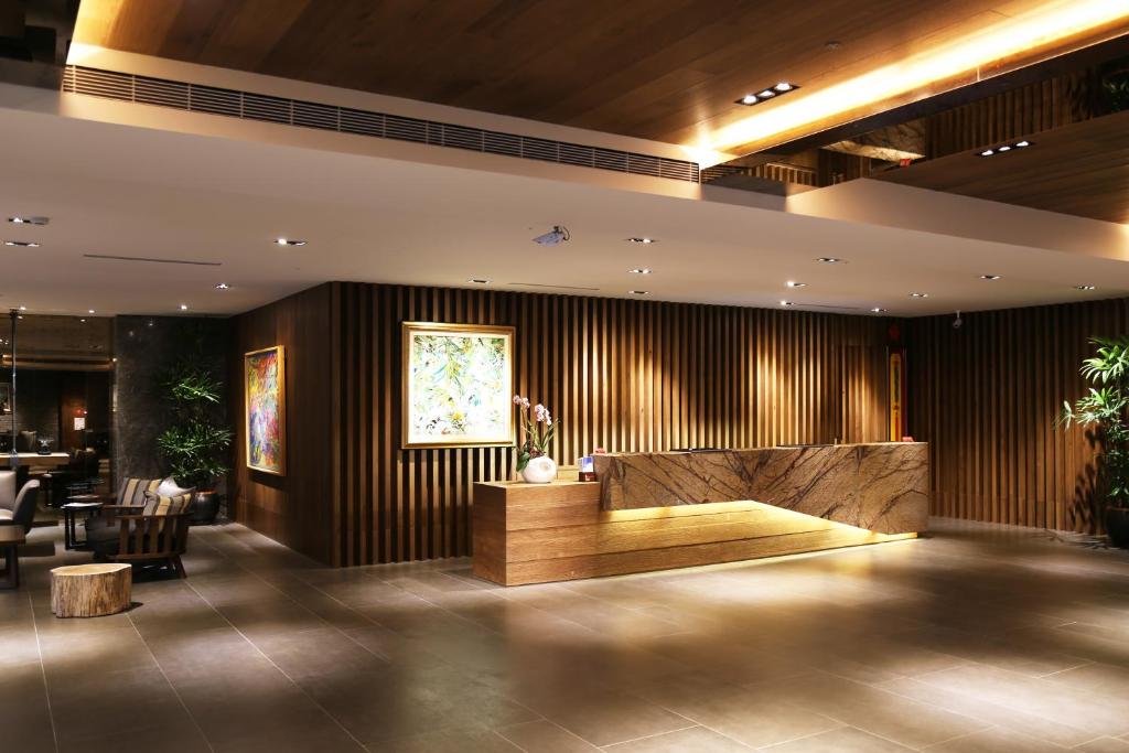 a lobby with a reception desk in a building at Chiayi Maison de Chine Hotel in Chiayi City