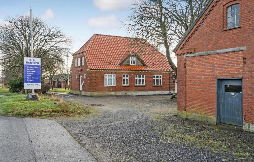 a brick house with a sign in front of it at 1 Bedroom Nice Apartment In Esbjerg V in Esbjerg
