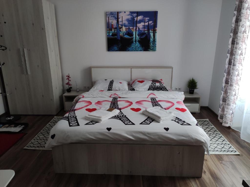 a bedroom with a large bed with hearts on it at Fanea Residence in Sibiu