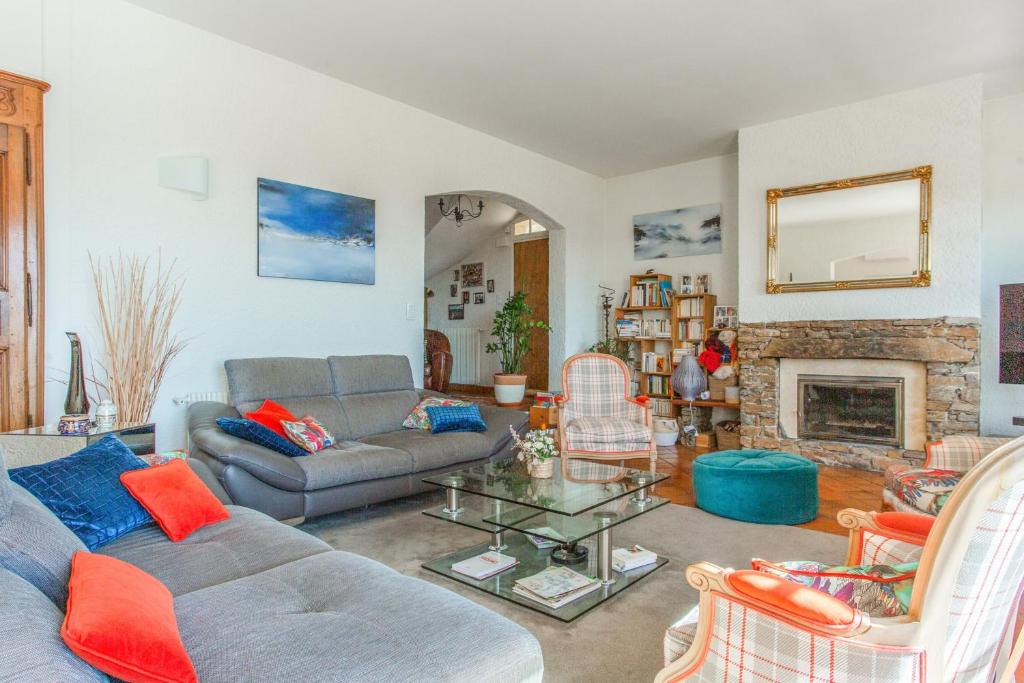 a living room with a couch and a fireplace at Maison du Baou - Welkeys in Toulon