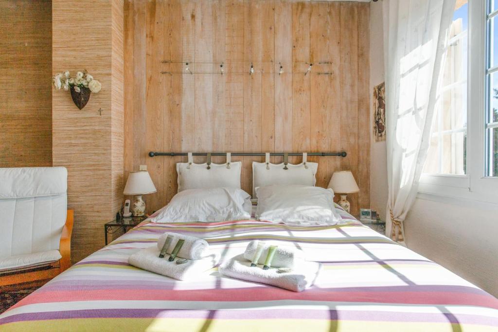a bedroom with a large bed with two pillows at Maison du Baou - Welkeys in Toulon