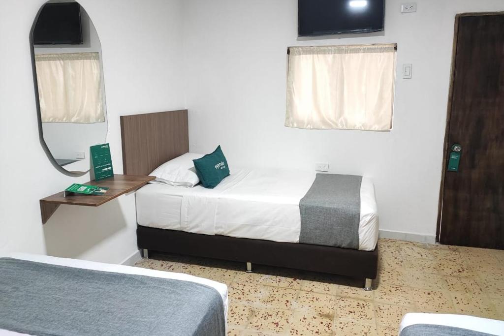 Letto o letti in una camera di Ayenda Hotel Helenas