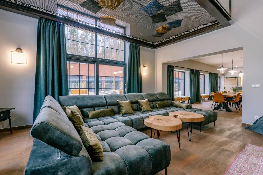 a living room with a couch and tables at vila FABRIKA in Vyhne