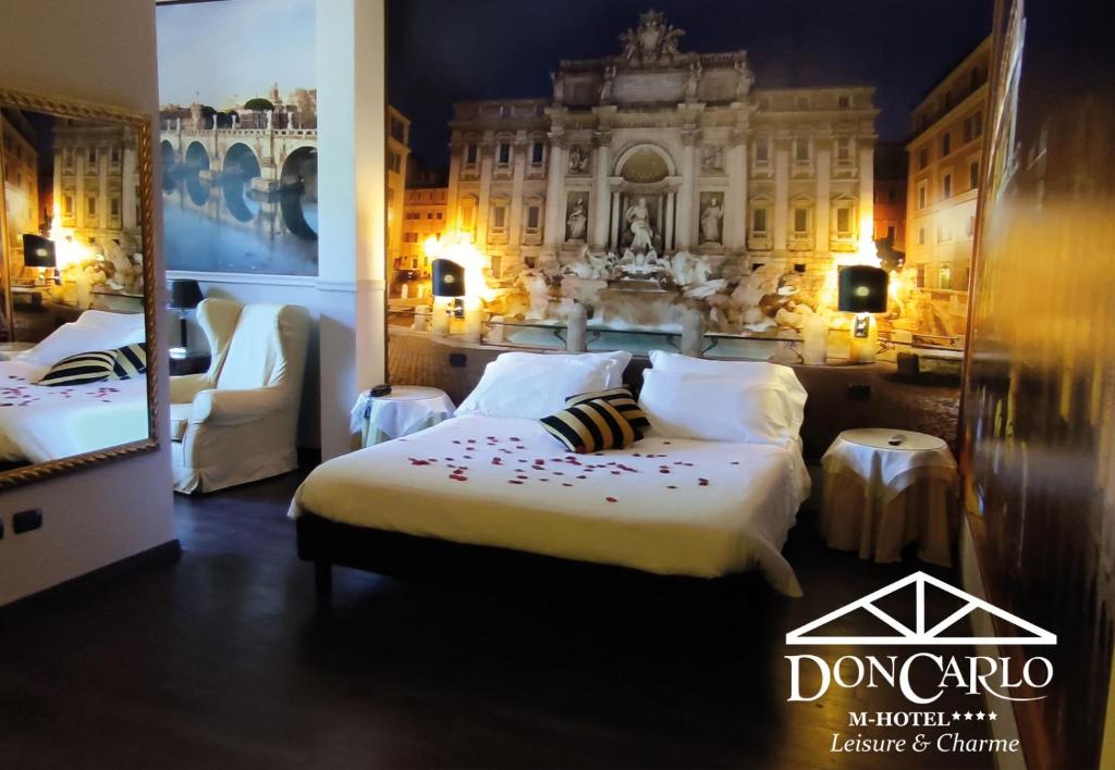 A bed or beds in a room at Hotel Don Carlo