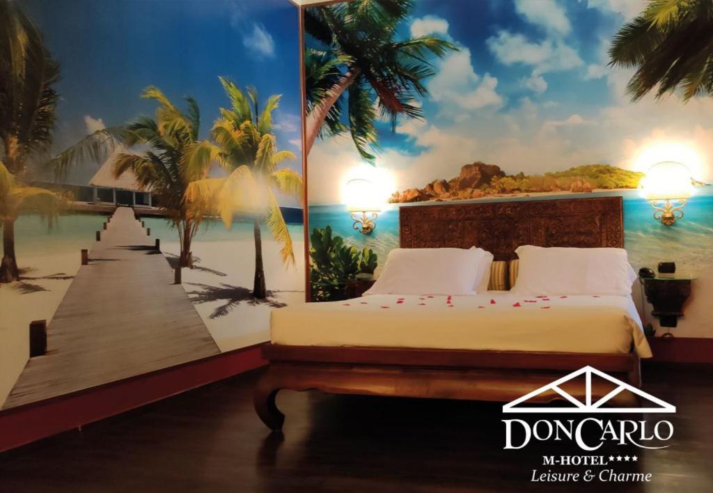 A bed or beds in a room at Hotel Don Carlo