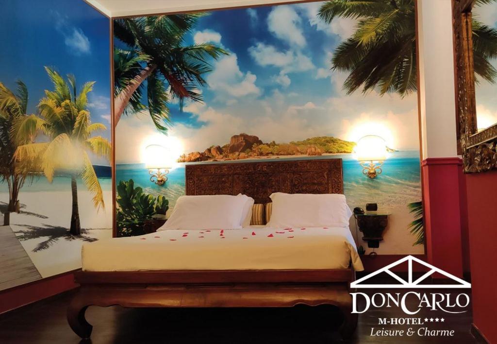 A bed or beds in a room at Hotel Don Carlo
