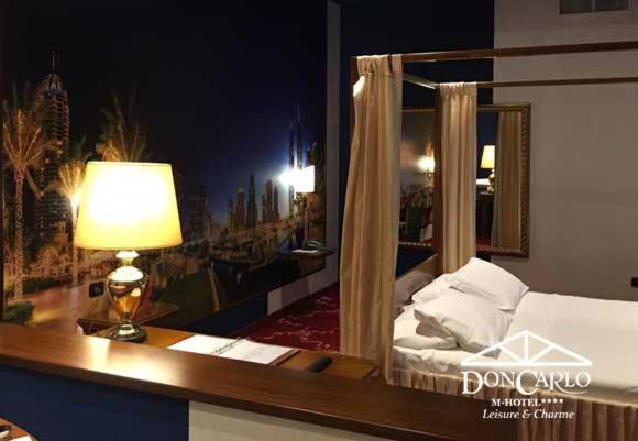 A bed or beds in a room at Hotel Don Carlo