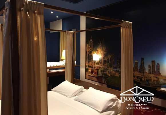 A bed or beds in a room at Hotel Don Carlo
