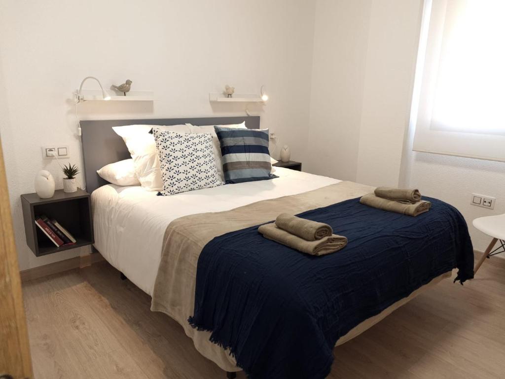 Magnifico apartamento nuevo La Alberca في مورسية: غرفة نوم بسرير كبير عليها منشفتين