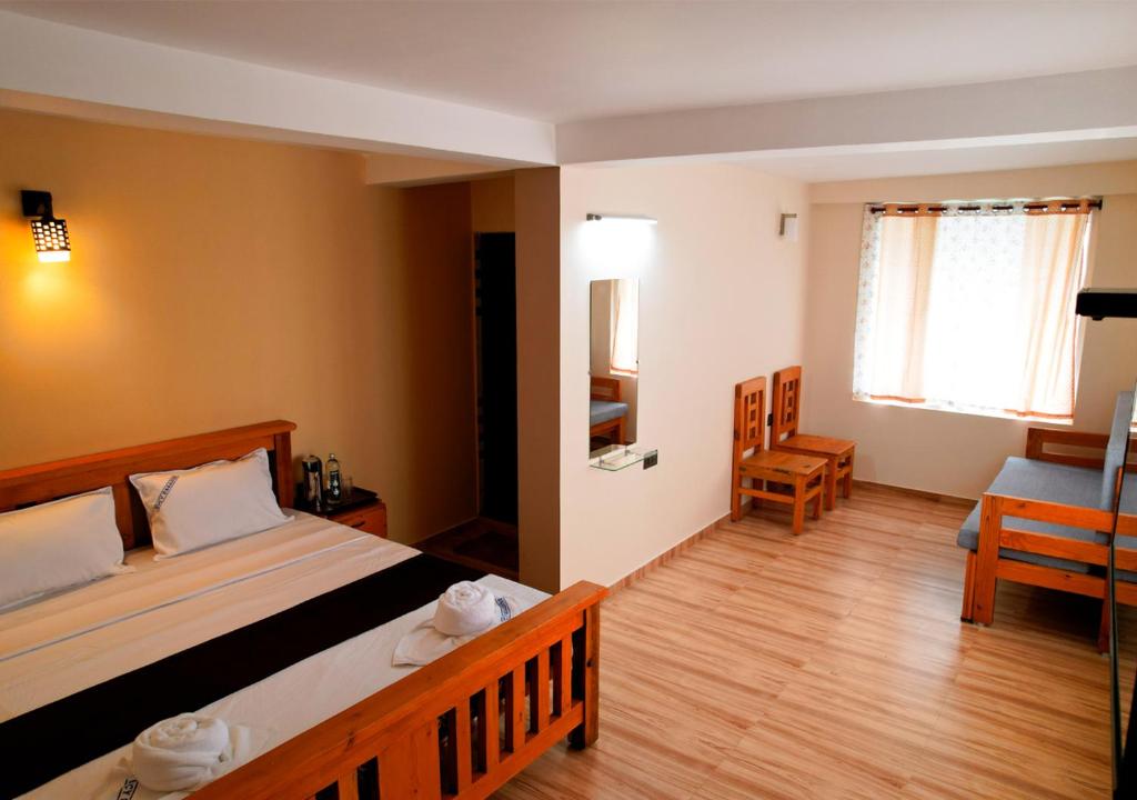 Postel nebo postele na pokoji v ubytování Lazo Eucy Paradise ,Kodaikanal