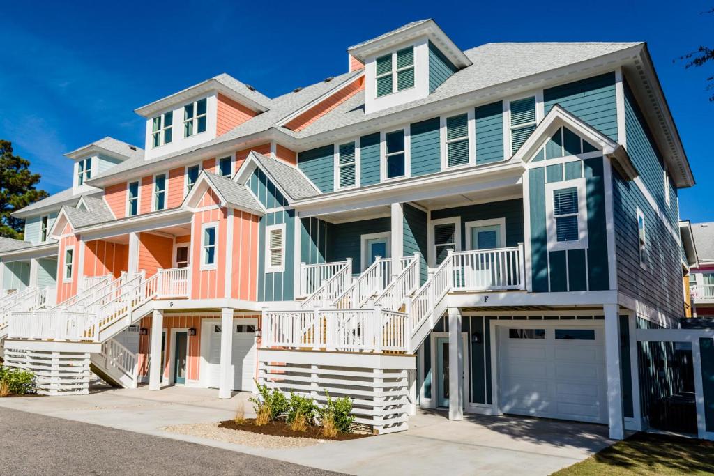 a large house with colorful houses at Cambridge Reserve by KEES Vacations in Kill Devil Hills