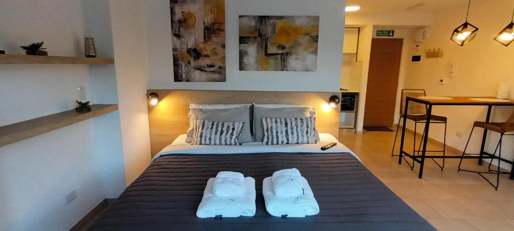 1 dormitorio con 1 cama con 2 zapatillas en D&G USH I en Ushuaia