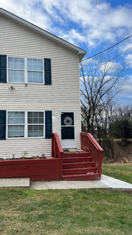 a house with a red bench in front of it at The McNeil Mansions in Harrisburg