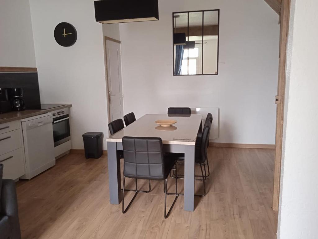 a dining room table and chairs in a kitchen at Les Hirondelles in Berck-sur-Mer