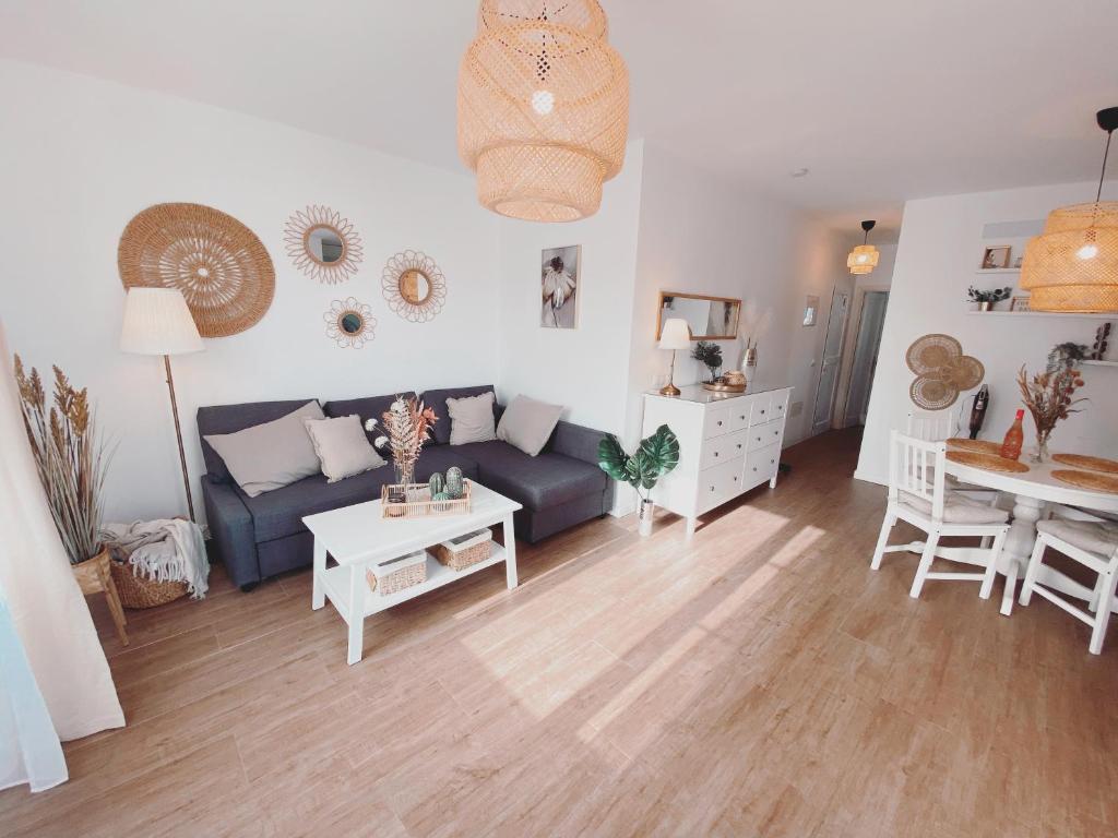 a living room with a couch and a table at Casa Rosalia Puerto del Carmen in Puerto del Carmen