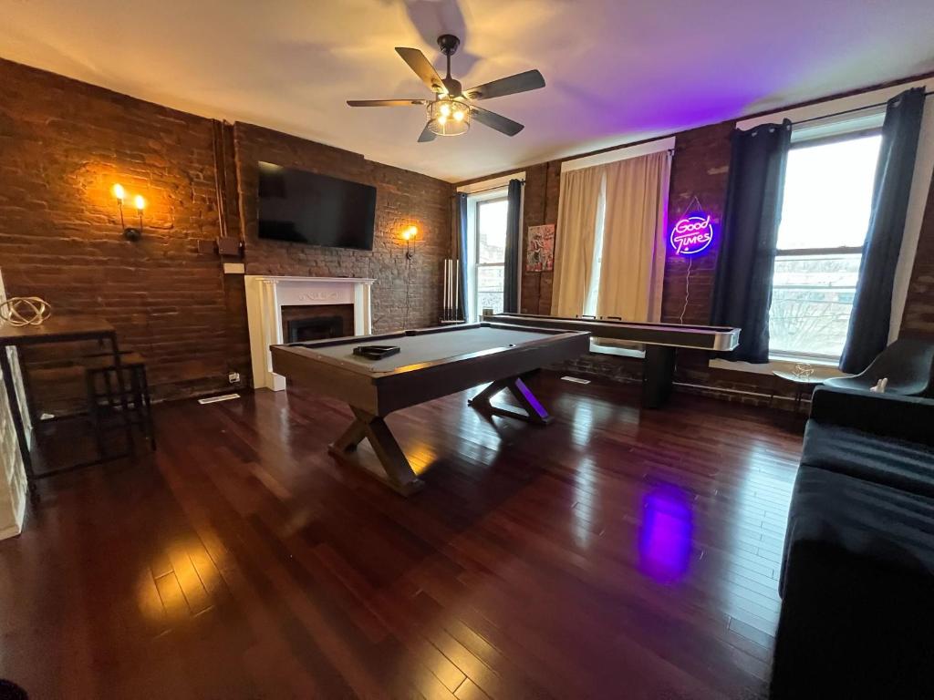 a living room with a pool table and a ceiling fan at Downtown Loft Sleeps 6 - Pool Table Shuffleboard in Louisville