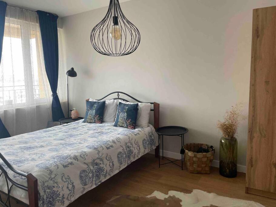 a bedroom with a bed and a chandelier at Annabella’s place in Veliko Tŭrnovo