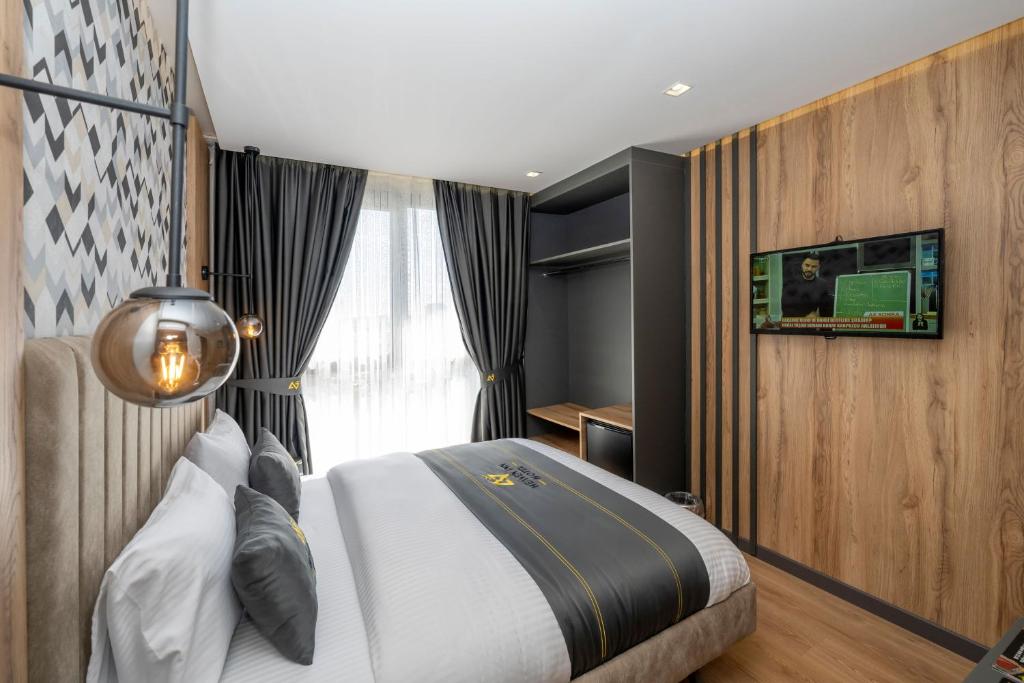 a bedroom with a large bed and a window at Heaven Inn Airport Hotel in Arnavutköy