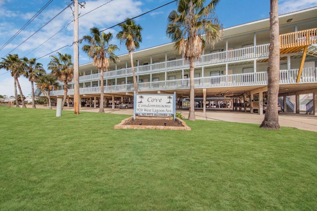 a large building with a sign in front of it at The Cove 205B by Vacation Homes Collection in Gulf Shores
