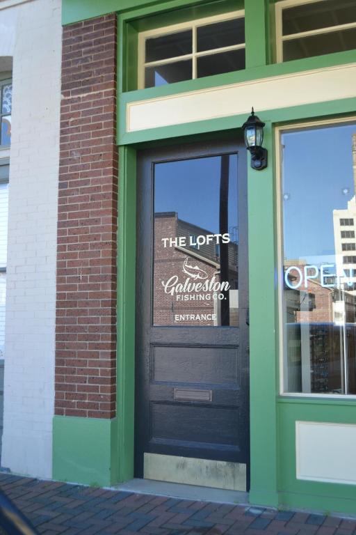 a door to a restaurant with a sign on it at The Lofts at GFC in Galveston