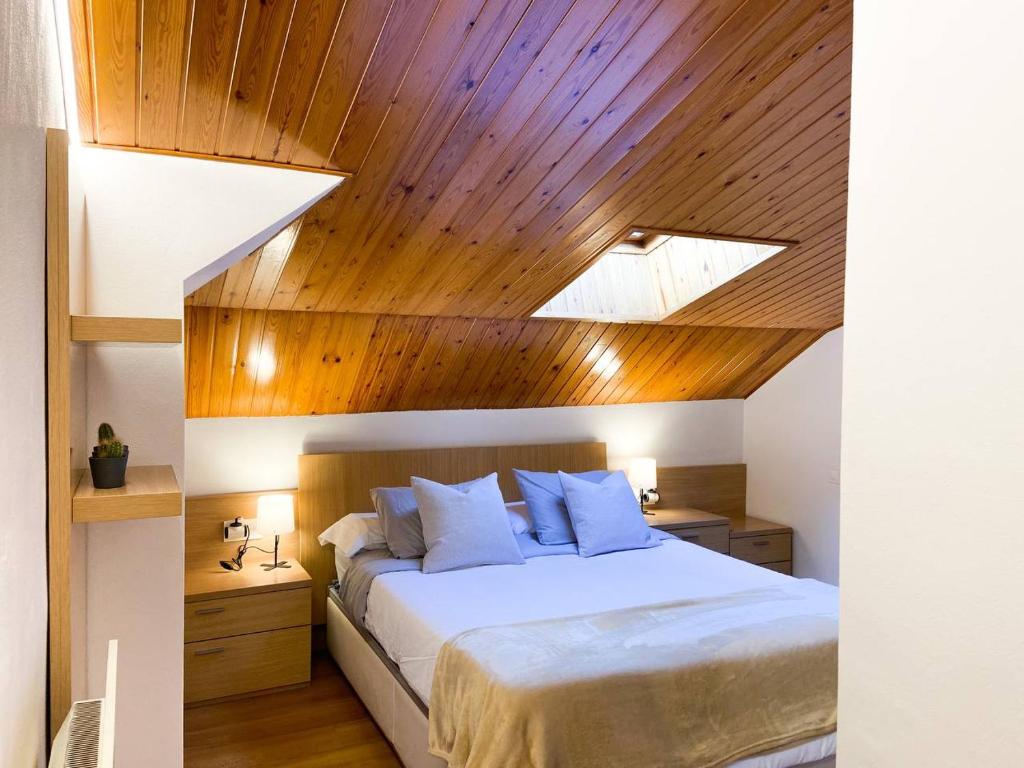 Rúm í herbergi á Elegante Ático Encamp - FREE Parking Wifi SmartTv - Con altillo y 2 baños completos! l by BonesVacances
