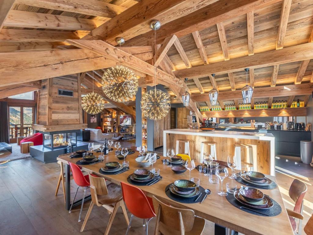 a dining room with a large wooden table and chairs at Chalet de prestige au cœur de Saint Martin de Belleville, à quelques pas des pistes - FR-1-570-38 in Saint-Martin-de-Belleville