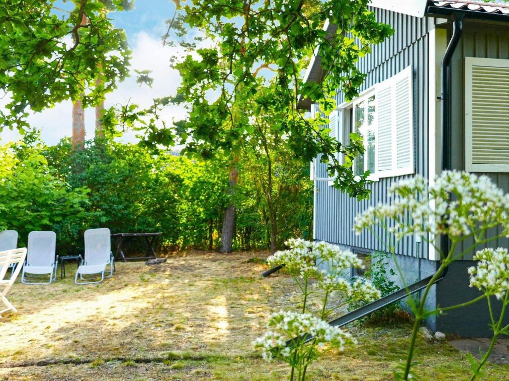 a yard with two chairs and a house at 6 person holiday home in 38472-By Traum in Tillingenabben