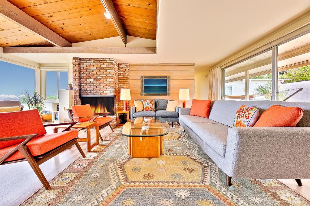 a living room with a couch and a fireplace at La Jolla Lookout in San Diego