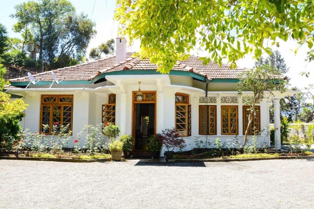 a house with a lot of flowers in front of it at Hotel Mount Pleasant in Bandarawela