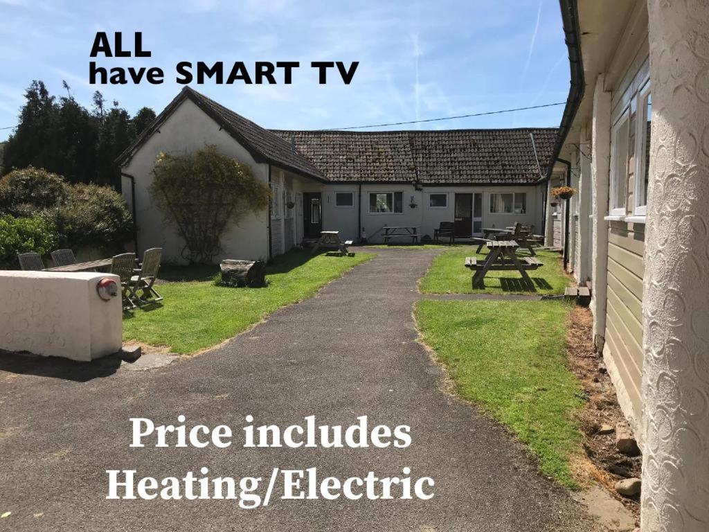 an image of a building with the words price includes heating electric at Court Farm Holiday Bungalows Ltd in Watchet