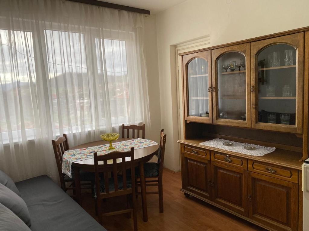 a kitchen with a table and a dining room at Stan na dan Boljevac in Boljevac