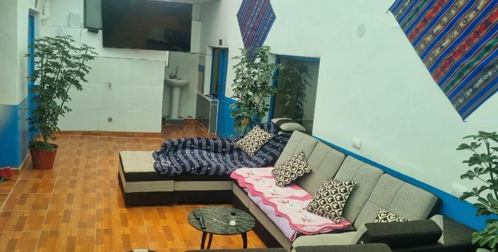 a living room with a couch with pillows on it at CASA HOSPEDAJE LA FLORIDA in Cusco