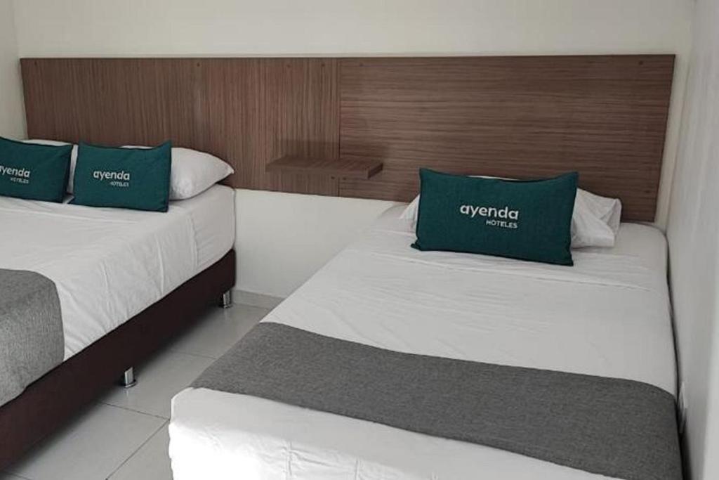 Letto o letti in una camera di Ayenda Hotel Helenas