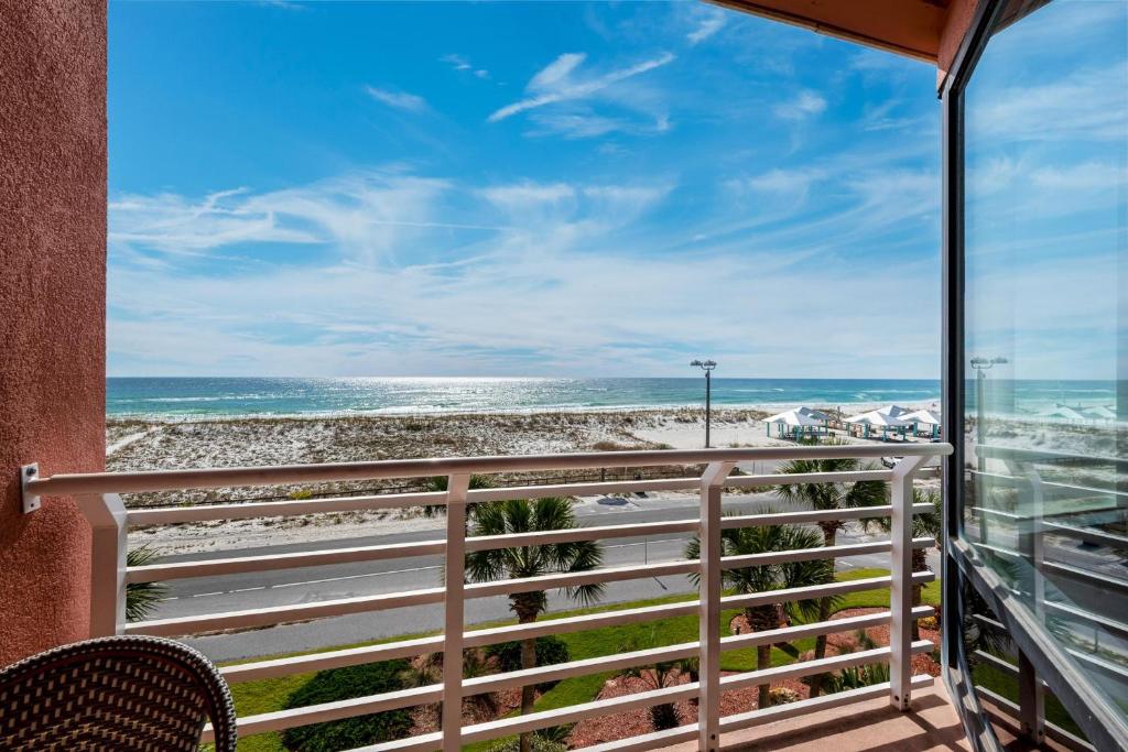 a balcony with a view of the beach at Palm Beach Club 3-235 in Pensacola Beach