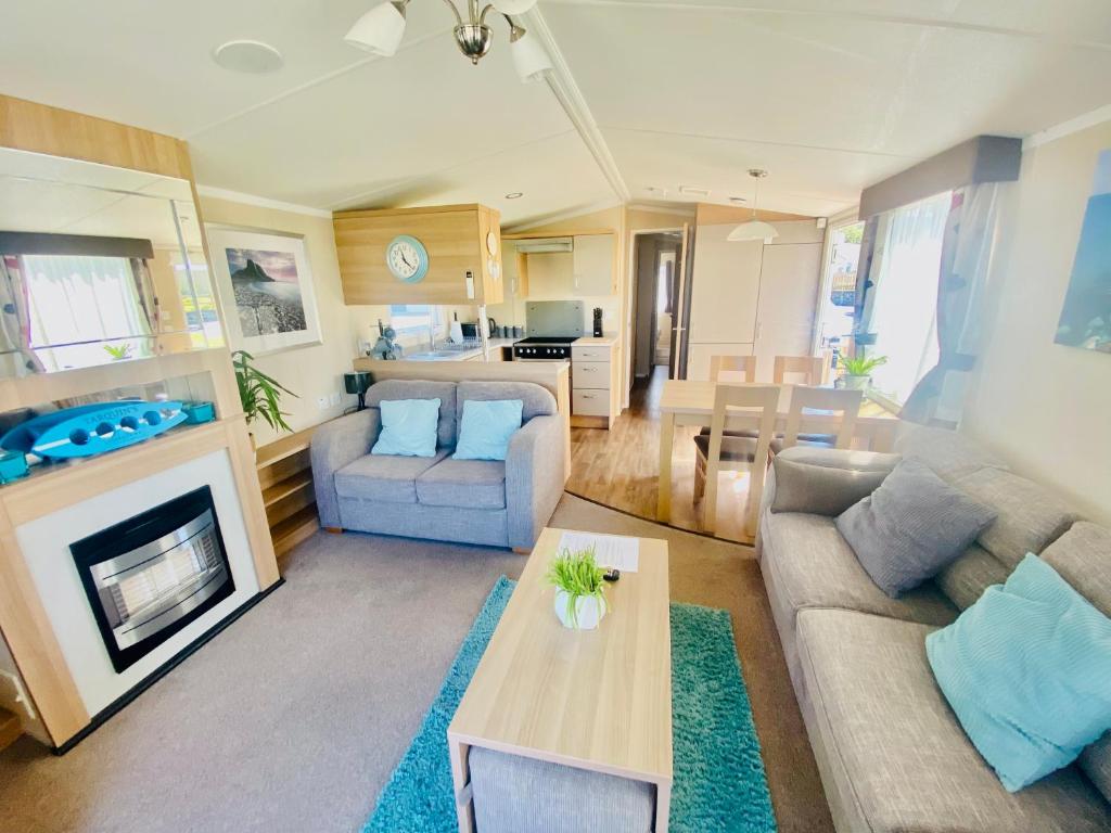 a living room with a couch and a table at B47 Caravan Seven Bays in Padstow