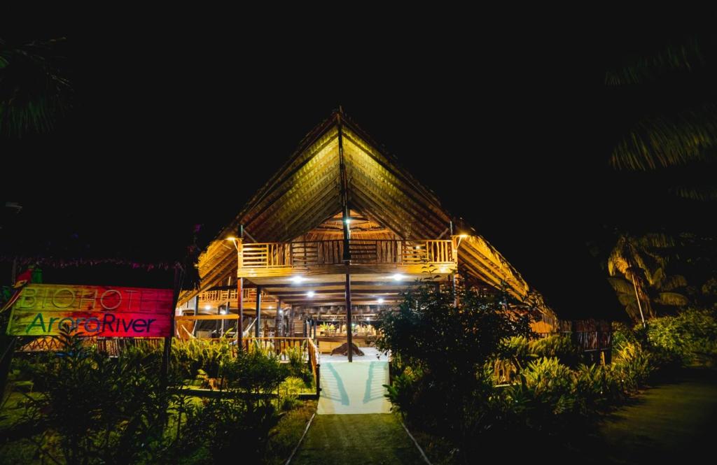 a night view of a building with lights at Biohotel Arara River in Leticia