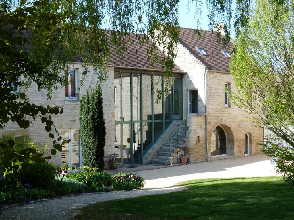 a brick house with a staircase in front of it at Clos de la Valette in Fontaine-Henry