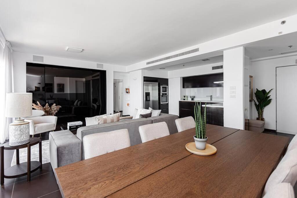 a dining room and living room with a table and chairs at Luxury apartment with a great view in Tel Aviv